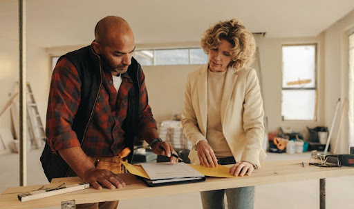 Homeowner and Hickey HVAC technician looking at plans for HVAC remodeling.