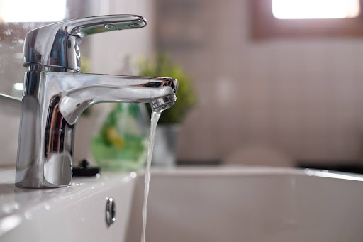 Broken faucet leaking water.